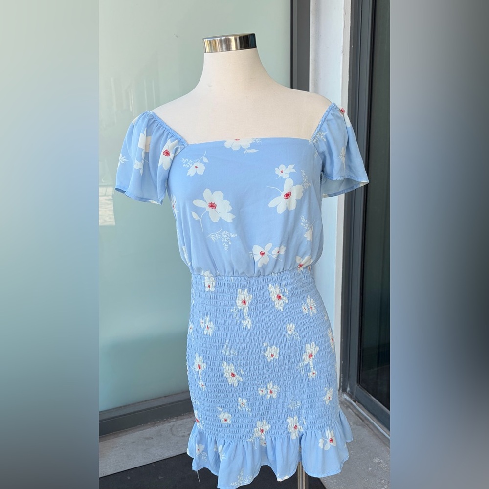 Row. A Blue Floral Dress with White and Red Details